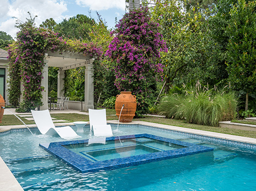 Custom in ground pool with patio and background design from CoastLife Pools South Florida